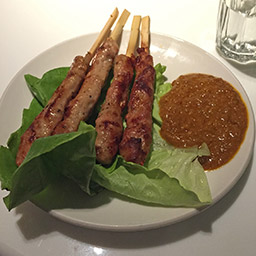 Pig-on-a-stick with peanut sauce