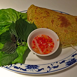 Bánh xèo, fried pancake with pork and lettuce wrap